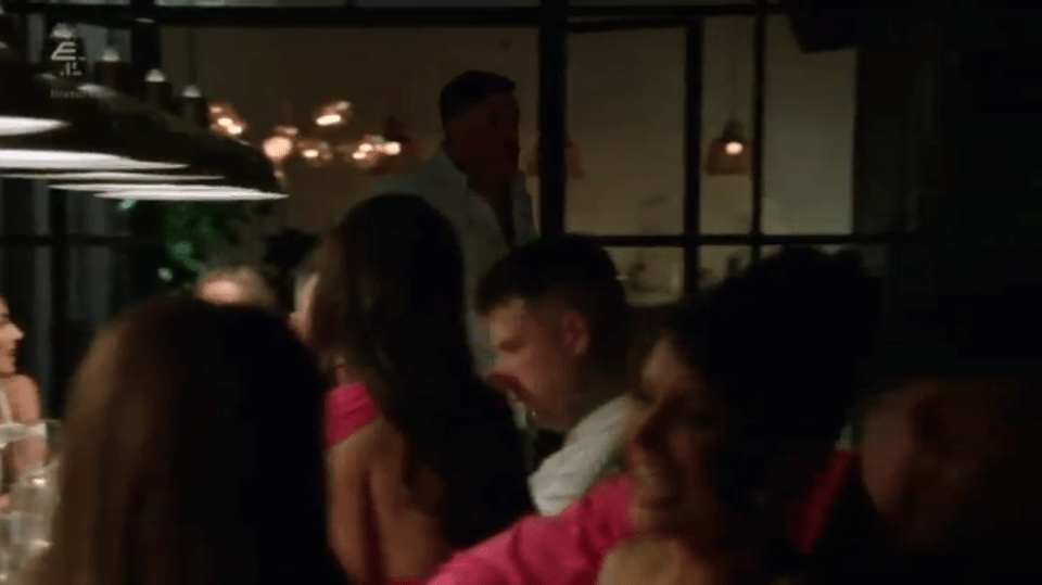 Man entering a dimly lit restaurant.