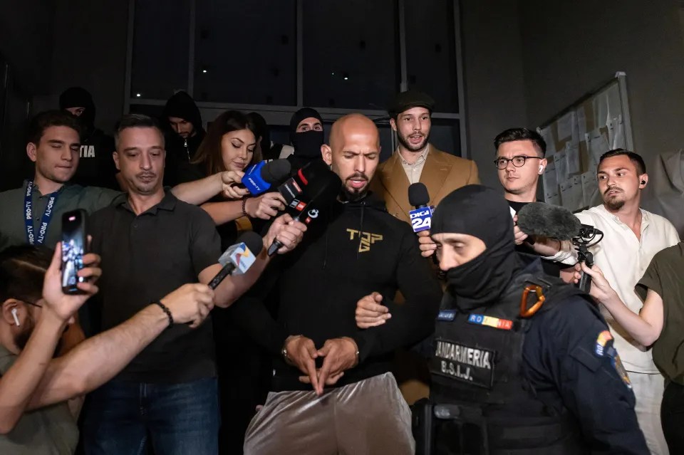 A man surrounded by reporters and police.