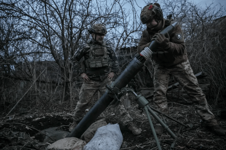 Soldiers loading a mortar.
