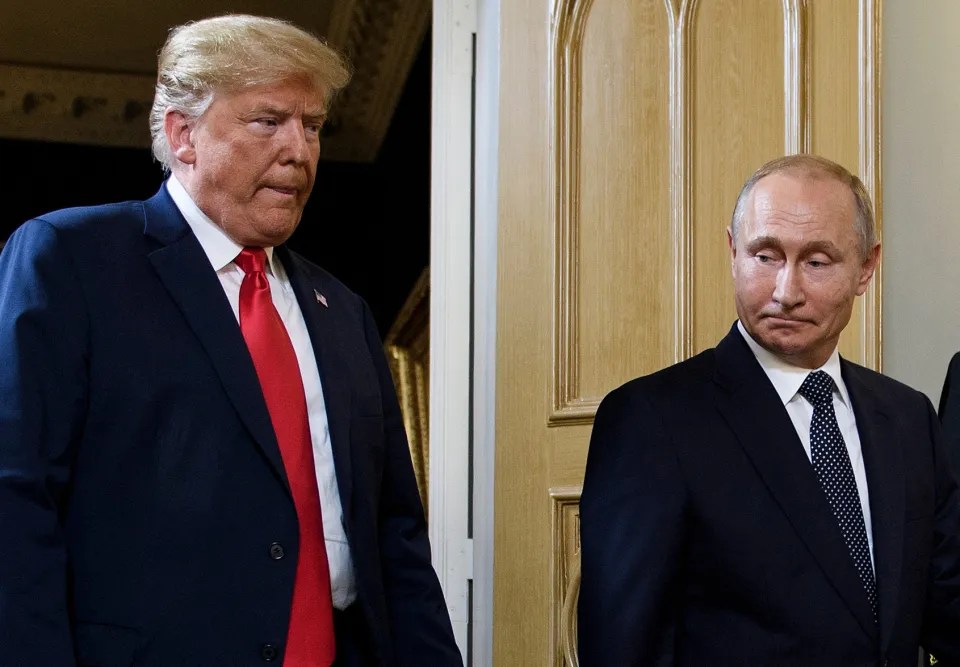 Donald Trump and Vladimir Putin standing near a doorway.