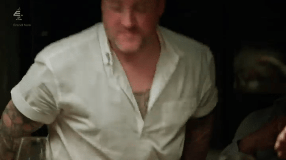 Man in a white shirt looking down.