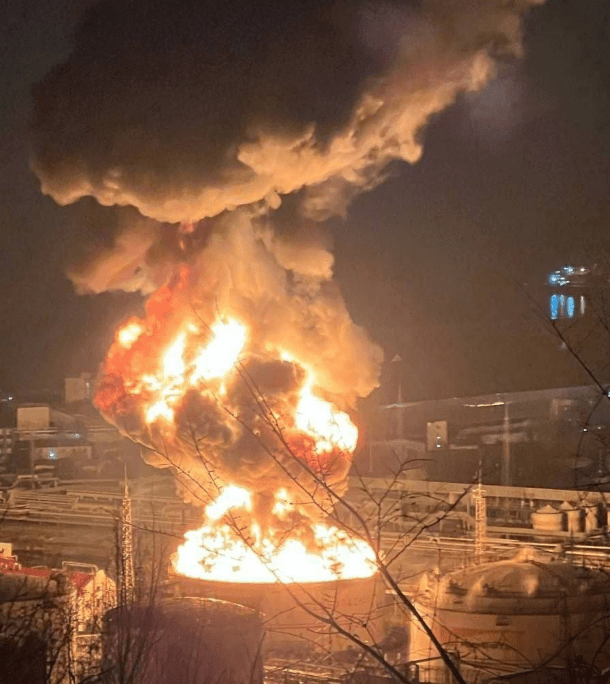 Large fire engulfing industrial storage tanks.