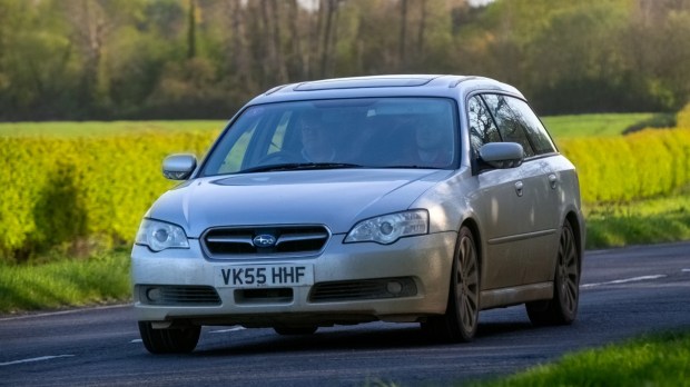 Bicester,UK- Apr 21st 2024: 2005 silver Subaru Legacy classic car driving on a British road
