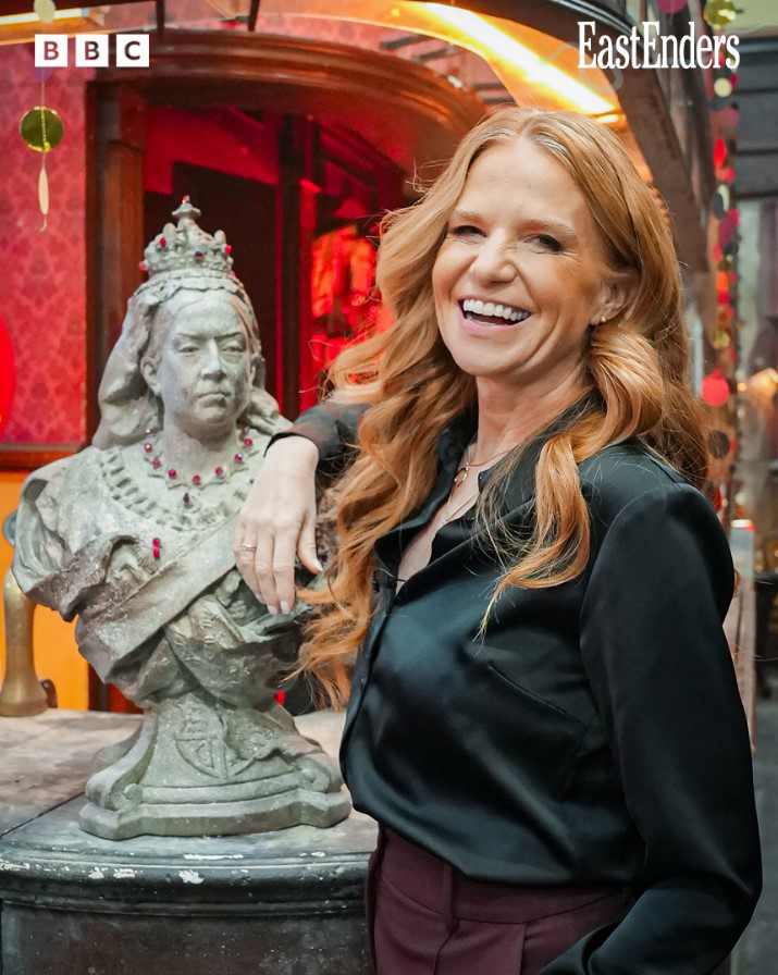 Patsy Palmer at an EastEnders leaving party, next to a bust of Queen Victoria.