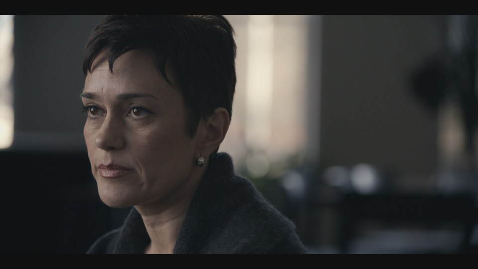 Close-up of a woman with short hair.