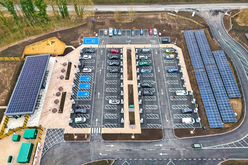 Aerial view of an electric vehicle charging station with solar panels.
