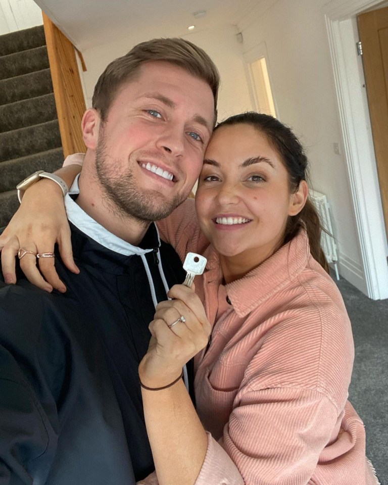 Jacqueline Jossa and Dan Osborne holding keys to their new home.