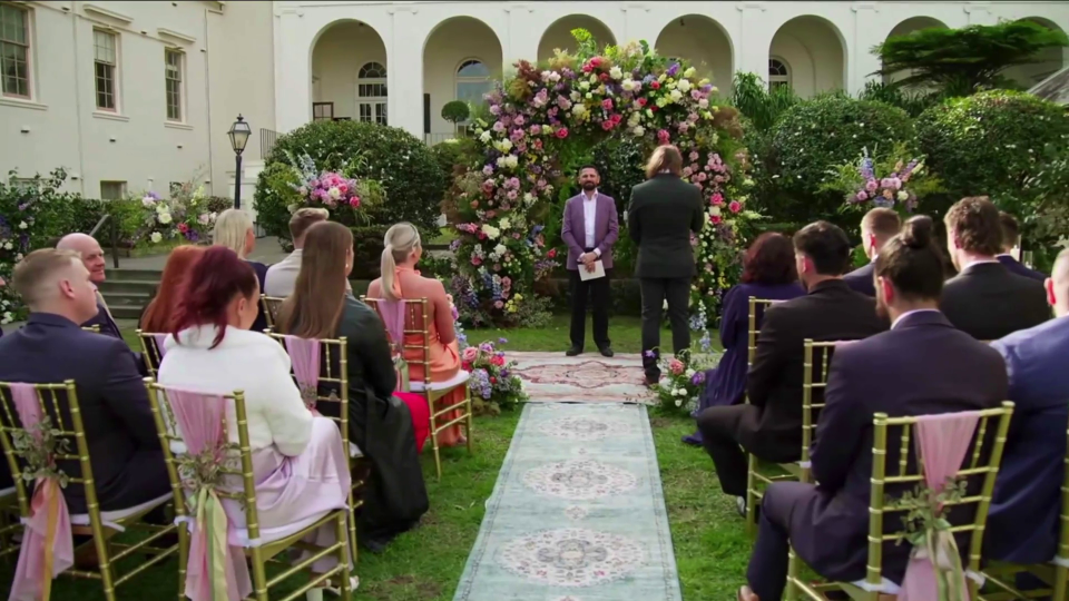 Wedding ceremony guests seated outdoors.