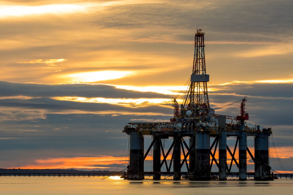 Offshore oil drilling rig at sunset.