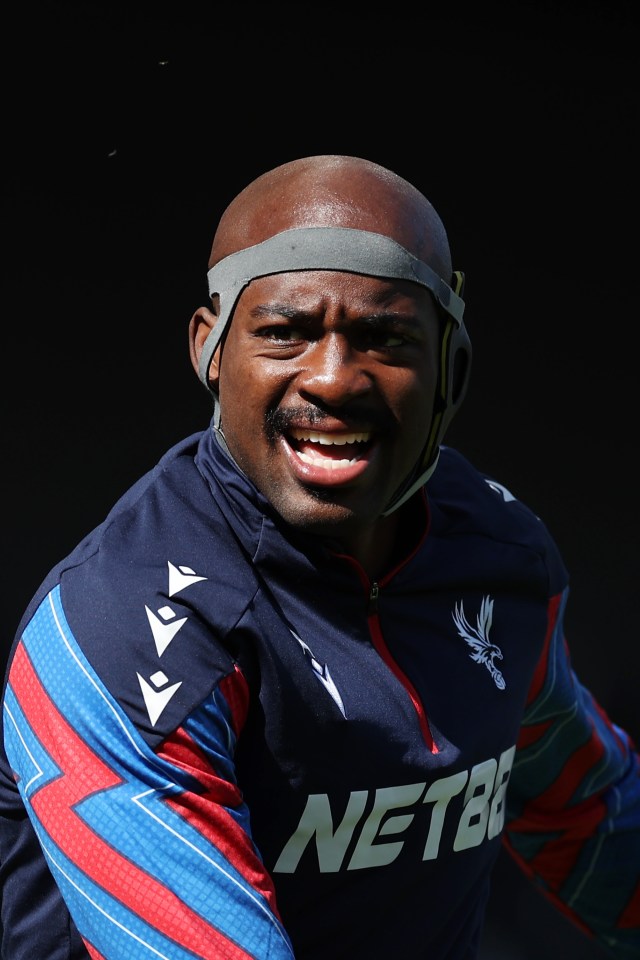Jean-Philippe Mateta of Crystal Palace warming up in a protective helmet.