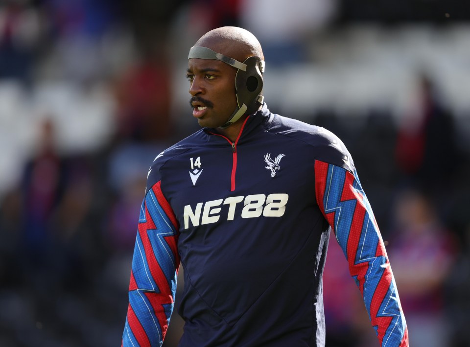 Jean-Philippe Mateta of Crystal Palace warming up in a protective facemask.