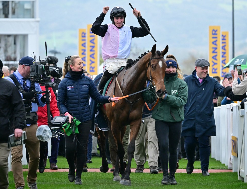Jockey Jack Kennedy celebrates winning a horse race.