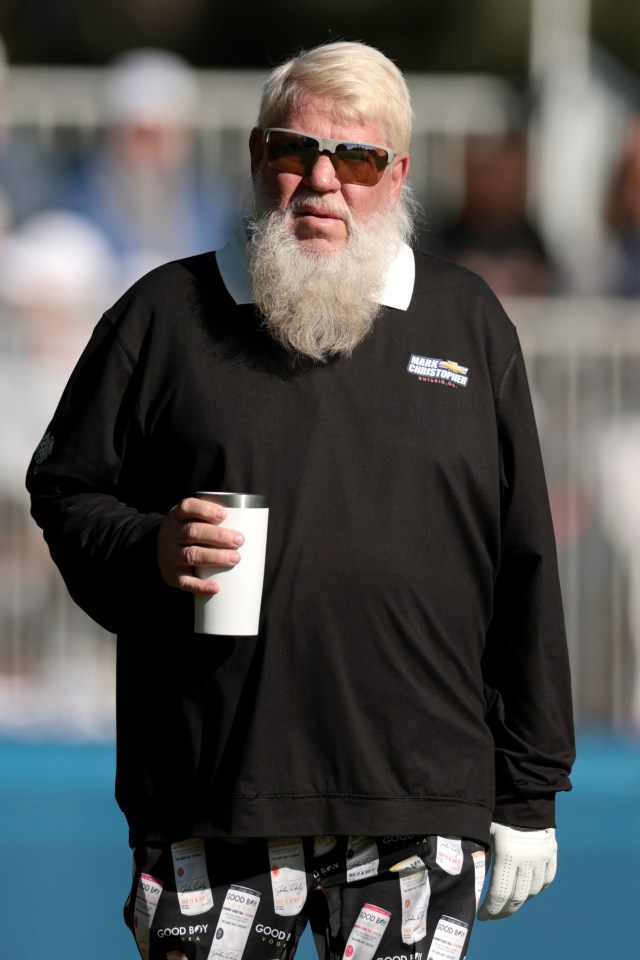 John Daly walking at a golf tournament.