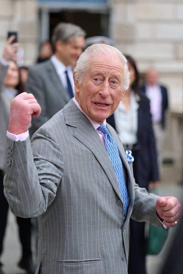 King Charles III waving during a visit.