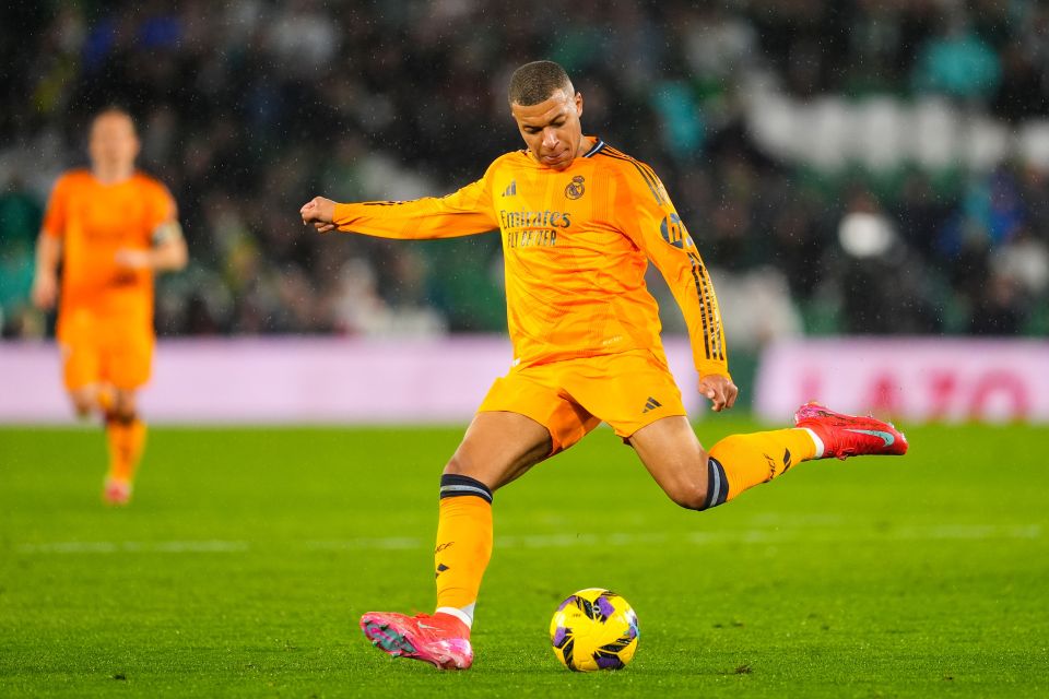 Kylian Mbappé of Real Madrid kicking a soccer ball.