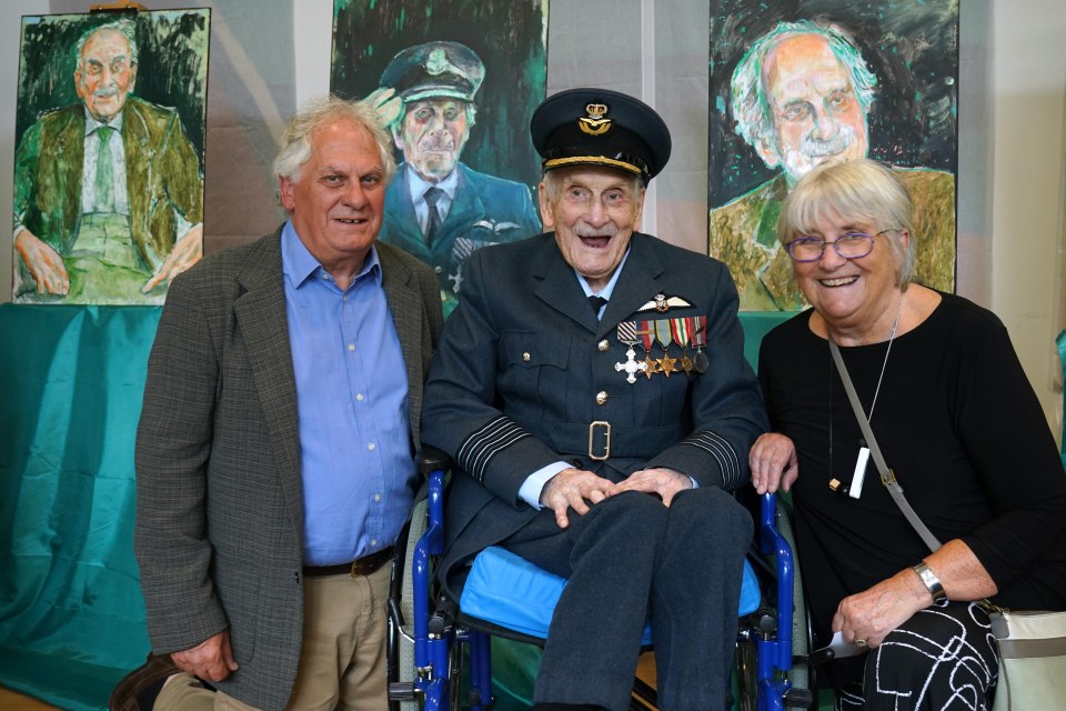 A Battle of Britain pilot, his family, and portraits of him at the British Embassy in Dublin.