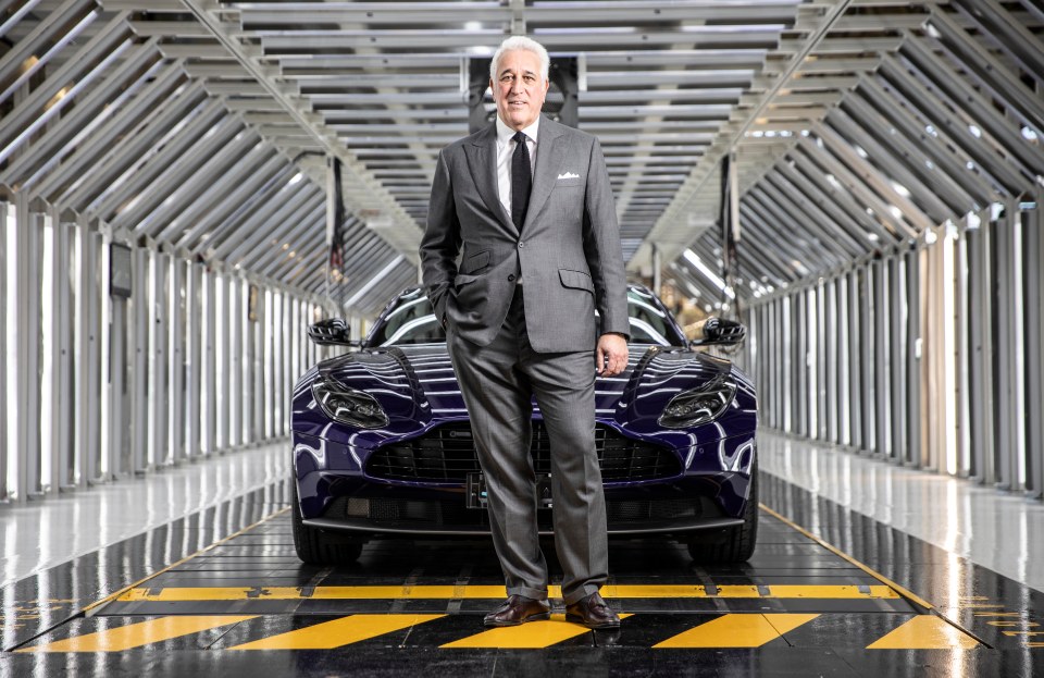 Lawrence Stroll, Aston Martin chairman, standing in front of a car in a factory.