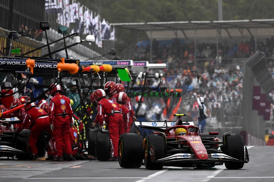 Lewis Hamilton's Ferrari SF-25 in the pit lane during a Formula 1 race.