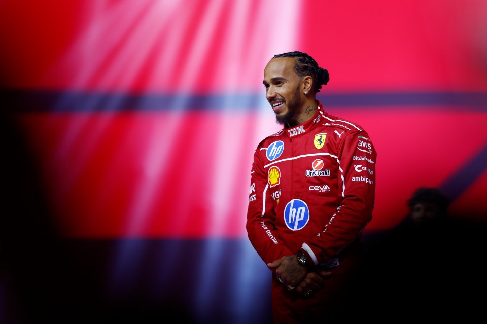 Lewis Hamilton in a Ferrari racing suit.