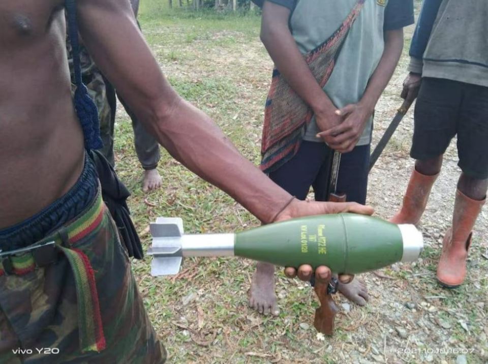 Person holding unexploded mortar.
