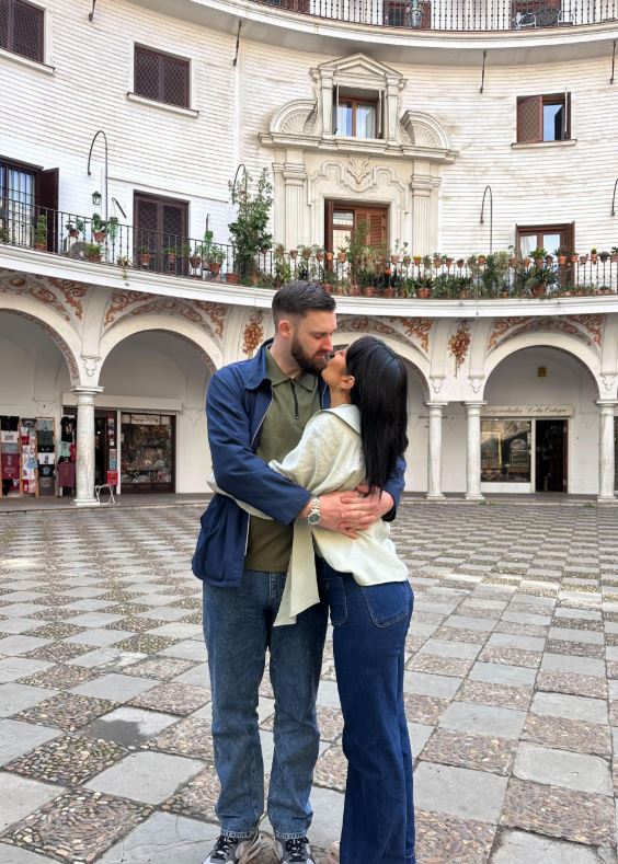 Sharon Gaffka and her boyfriend embracing in a courtyard.