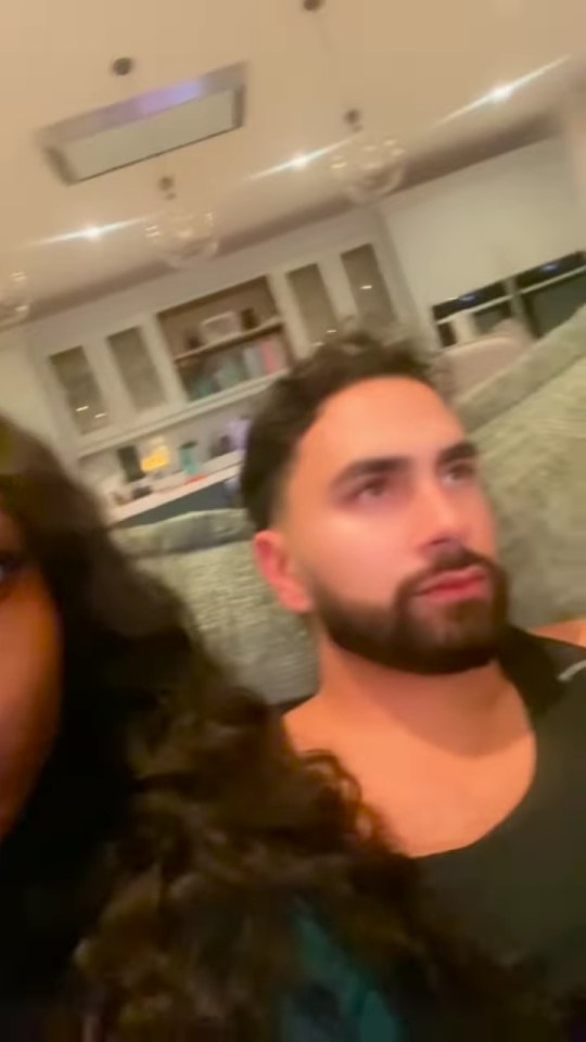 Whitney and Lochan from Love Island on a couch.