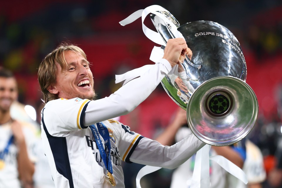 Luka Modric of Real Madrid celebrates with the UEFA Champions League trophy.