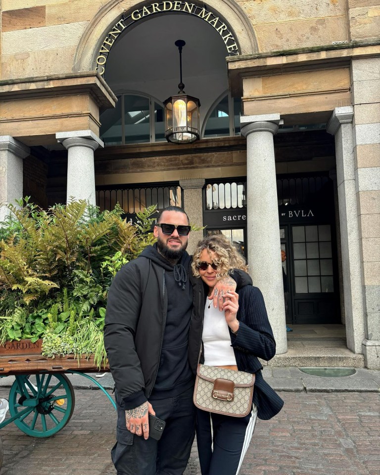 Couple posing in front of Covent Garden Market.