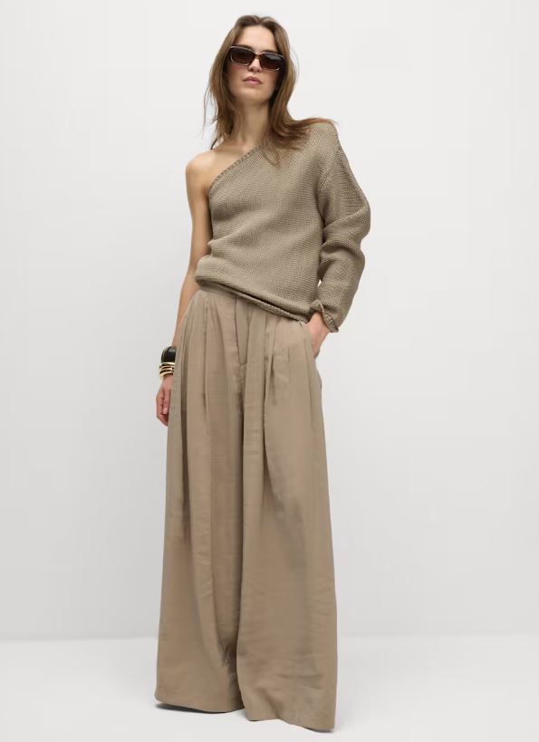 Model wearing a taupe one-shoulder knitted top and wide-leg trousers.