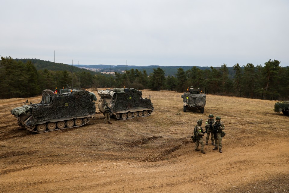 Lithuanian soldiers at a command post during a military training exercise.