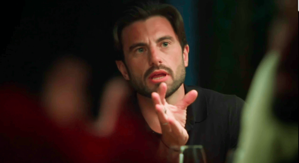 A man gestures emphatically while speaking.