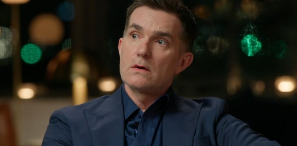 A man in a suit looks surprised.