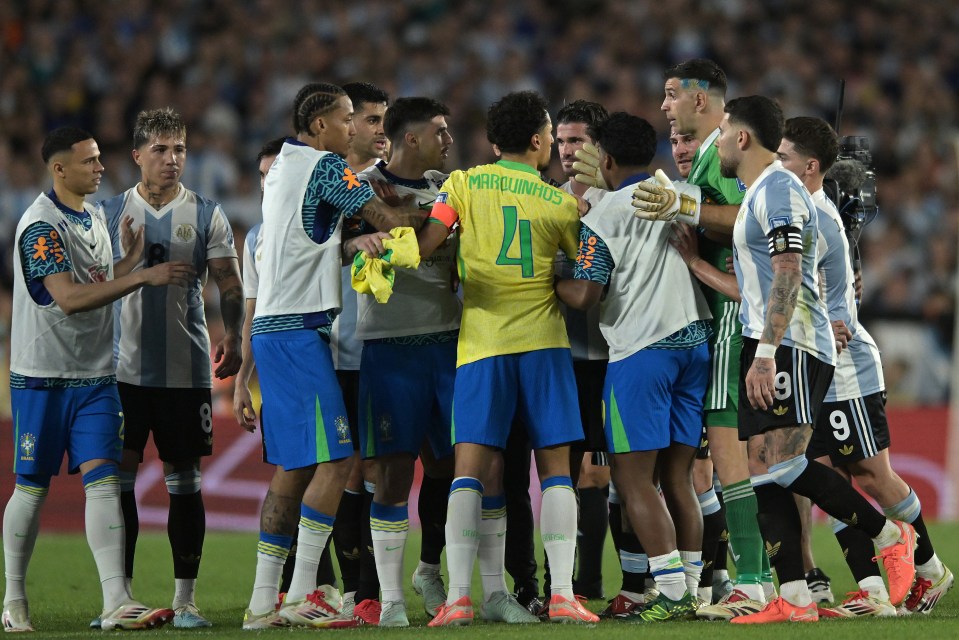 Brazilian and Argentinian soccer players arguing on the field.