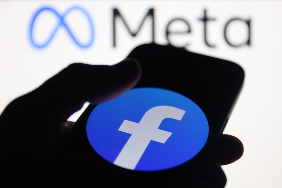 Photo illustration of a person using a smartphone displaying the Facebook logo.