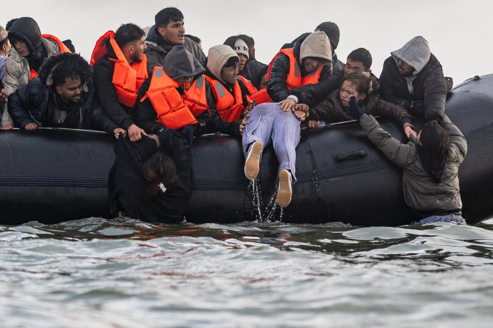 Migrants in a small boat attempting to cross the English Channel.