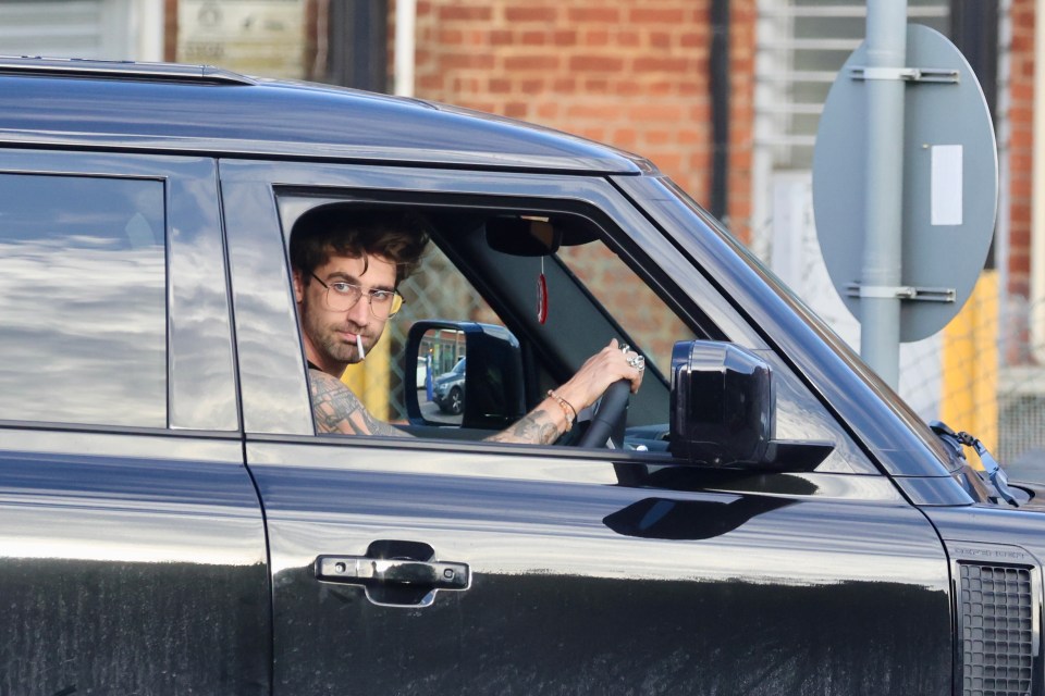 Chris Taylor driving a black Land Rover Defender.