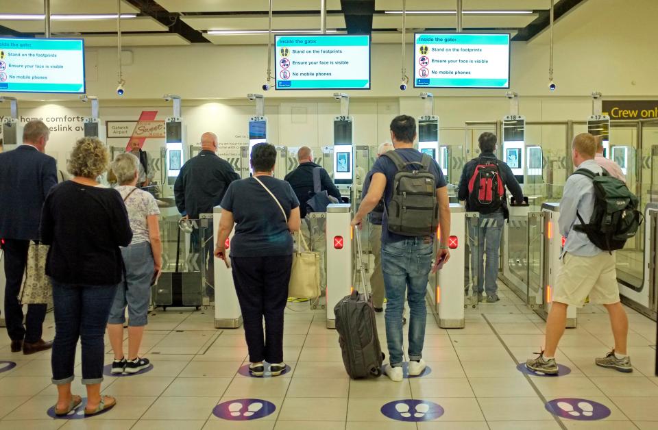 Passengers using e-passport gates at an airport.