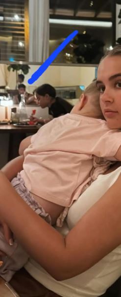 Woman holding a young child.