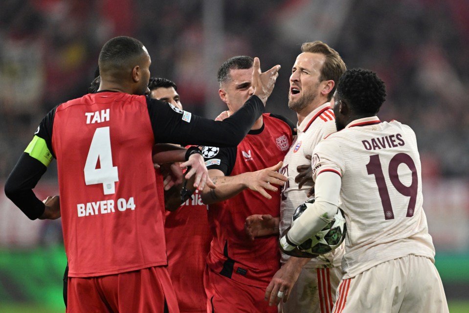 Soccer players arguing on the field.