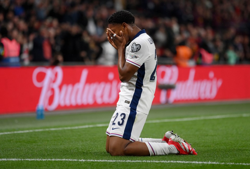 Myles Lewis-Skelly of England kneeling on the field, head in hands.