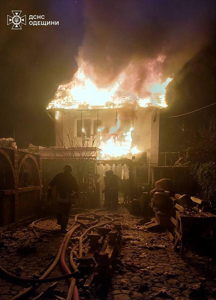 A house engulfed in flames during a nighttime attack.