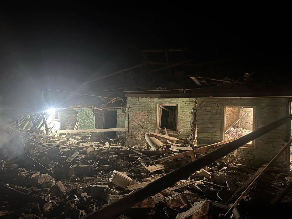 Debris of a destroyed building at night.