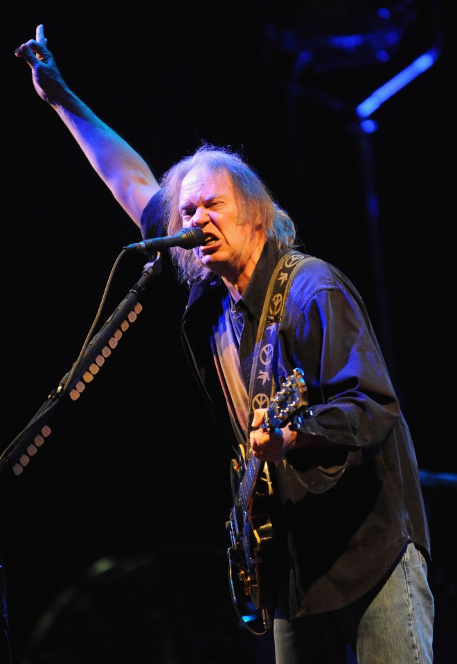 Neil Young performing at a music festival.