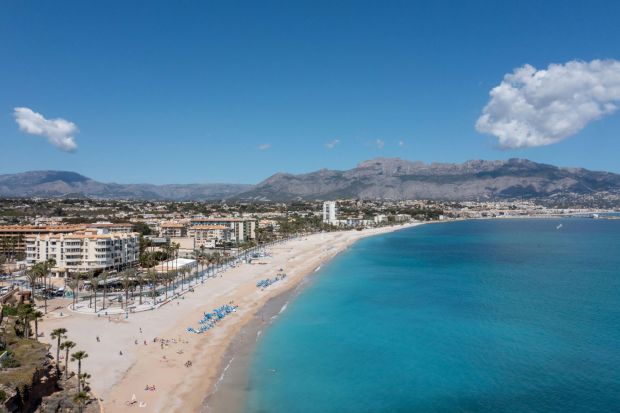 An image collage containing 1 images, Image 1 shows Aerial view of L'Albir beach in Spain, showing the town, beach, and mountains