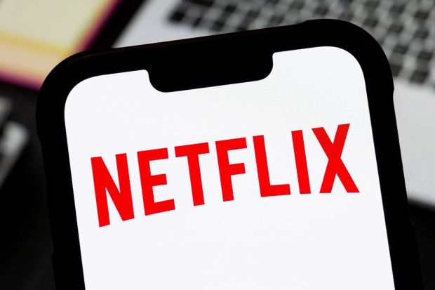 An image collage containing 1 images, Image 1 shows Illustration of the Netflix logo on a smartphone screen
