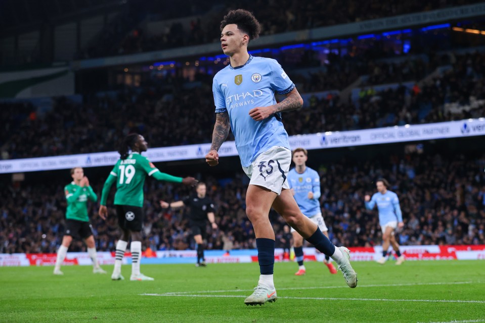 Manchester City players celebrating a goal.