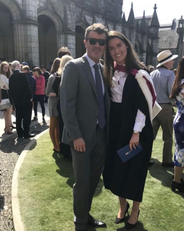 A man and woman at a graduation ceremony.