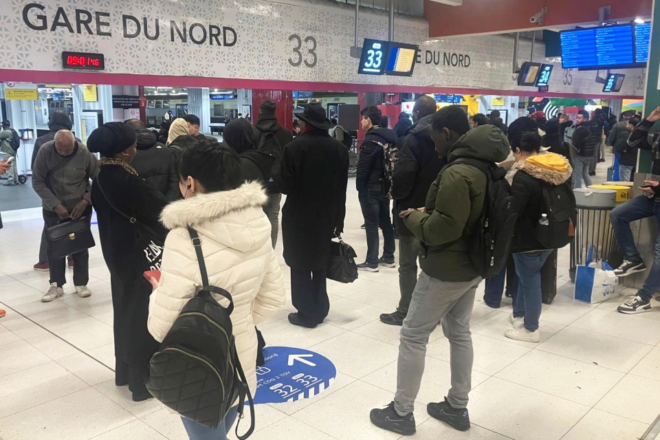 Passengers waiting at Gare du Nord station in Paris due to a World War II unexploded bomb.