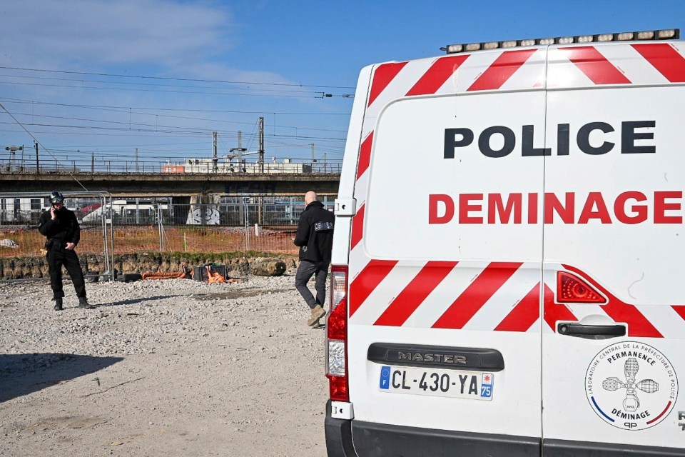 Bomb disposal officers near a large unexploded World War II bomb in Paris.