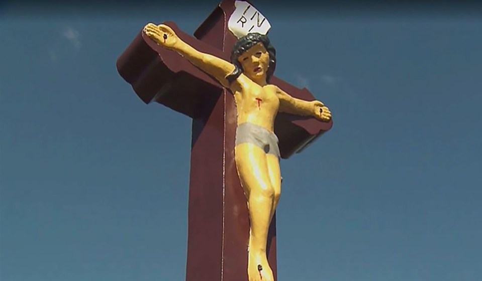Crucifixion statue on a dark brown cross.